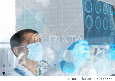 Doctor examines brain scans in modern hospital setting during the day 132158362