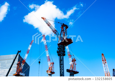 A landscape of tower cranes at a large construction site. b-2 High saturation contrast 132158605