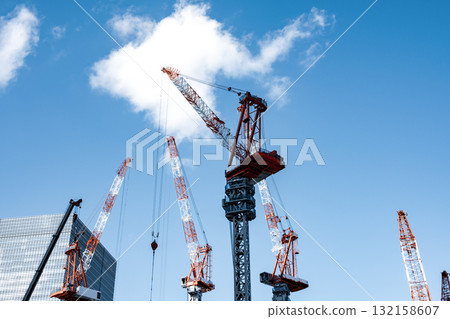 A scene of tower cranes lined up at a large-scale construction site b-4 Cool color 132158607