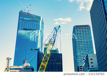 Construction work continues around Gofukubashi in Yaesu, Tokyo. October 2025. Warm and cool colors emphasized. 132158763