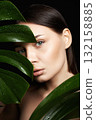 beautiful girl in palm leaves. Beautiful woman with Make-up 132158885