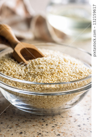 Roasted sesame seeds in bowl on kitchen table. Roasted sesame seeds in bowl on kitchen table. 132159617
