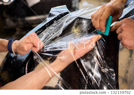 Applying a Protective Film on the Surface of Your Car for Enhanced Durability and Shine Applying a Protective Film on the Surface of Your Car for Enhanced Durability and Shine 132159702
