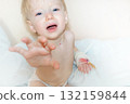 A small child in the hospital asks to be picked up by his mother 132159844