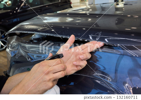 The comprehensive Car Wrap Application Process conducted within a Modern Showroom environment The comprehensive Car Wrap Application Process conducted within a Modern Showroom environment 132160711