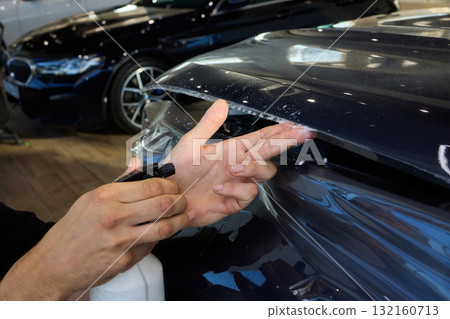 The comprehensive Car Wrap Application Process conducted within a Modern Showroom environment The comprehensive Car Wrap Application Process conducted within a Modern Showroom environment 132160713