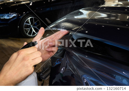 The comprehensive Car Wrap Application Process conducted within a Modern Showroom environment The comprehensive Car Wrap Application Process conducted within a Modern Showroom environment 132160714