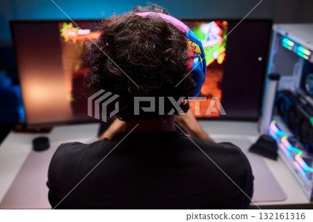 Enjoying an exciting gaming session with a controller and large screen for immersive gameplay Enjoying an exciting gaming session with a controller and large screen for immersive gameplay 132161316