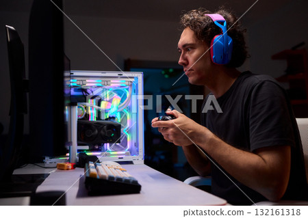 Enjoying an exciting gaming session with a controller and large screen for immersive gameplay 132161318