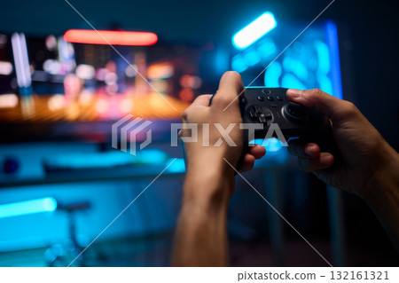 Enjoying an exciting gaming session with a controller and large screen for immersive gameplay 132161321