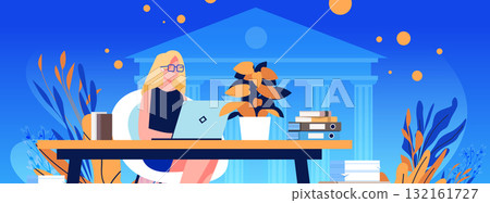 Woman working laptop office desk government building background modern workplace plants books blue orange color scheme web banner 132161727