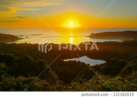 Scenery of the sun setting over the Sea of Japan seen from Hachimadodai, overlooking Ninomegata and Toga Bay on the Oga Peninsula in Akita Prefecture. Ver. 1 132162019