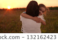 A little girl runs to her mother at sunset, Family reunion in the field, Warm sunset embrace, Joyful child in nature, Mother and daughter happy moment, Open arms and big smiles, Summertime meadow 132162423