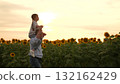 Father and daughter in sunflower field at sunset, happy family in summer, dad carrying child on shoulders, sunny day in nature, enjoying time together outdoors, bonding in the countryside, beautiful 132162429