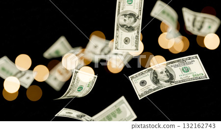 Falling hundred dollar bills on black background with bokeh lights, money rain of 100 dollar banknotes, finance, wealth and success concept 132162743