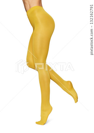 Beautiful long fit female legs in yellow tights on white background 132162791