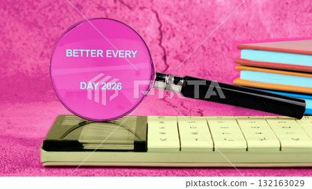 A magnifying glass rests on a calculator, displaying the words Better Every Day 2026. Bright pastel notebooks stand nearby, creating a vibrant setting for daily motivation and learning A magnifying glass rests on a calculator, displaying the words Better Every Day 2026. Bright pastel notebooks stand nearby, creating a vibrant setting for daily motivation and learning 132163029