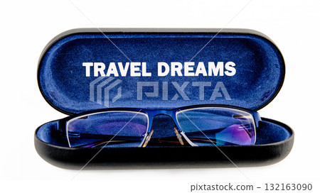 Stylish eyeglasses nestled in a sleek case adorned with the words travel dreams inspire wanderlust. A reminder to explore new horizons and seek adventure awaits 132163090