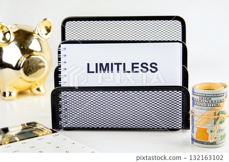 A neatly organized workspace features a black mesh file holder with a notepad that reads LIMITLESS, a gold piggy bank, a stack of cash, and a calculator, symbolizing financial growth A neatly organized workspace features a black mesh file holder with a notepad that reads LIMITLESS, a gold piggy bank, a stack of cash, and a calculator, symbolizing financial growth 132163102