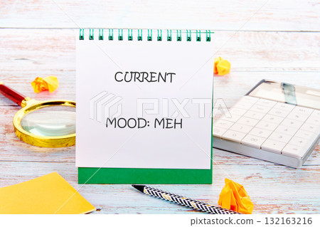 A notepad displays the words current mood meh as paper crumples lay around. A calculator and magnifying glass hint at daily tasks, evoking a sense of monotony and routine 132163216