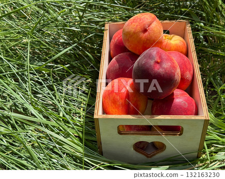 Juicy ripe peaches fruits in crate 132163230