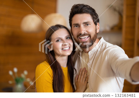 Smiling man and woman feeling excited and joyful together Smiling man and woman feeling excited and joyful together 132163481
