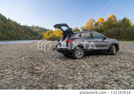 Woman Relaxing in Car Trunk in Nature 132163616