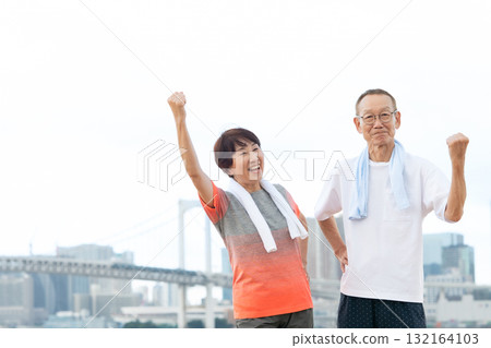 Senior couple portrait fist pump 132164103