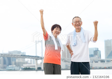 Senior couple portrait fist pump 132164106