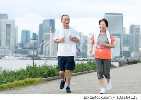 Senior couple walking jogging Senior couple walking jogging 132164125