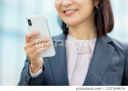 Business woman with a smartphone 132164634