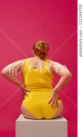 Fashion portrait of plus-size woman in yellow swimsuit strong confident pose Fashion portrait of plus-size woman in yellow swimsuit strong confident pose 132164708