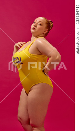 Fashion portrait of confident plus-size model in yellow swimsuit expressing attitude and power Fashion portrait of confident plus-size model in yellow swimsuit expressing attitude and power 132164715