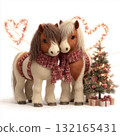 Two festive toy ponies in scarves surrounded by holiday decorations and a small Christmas tree with gifts 132165431