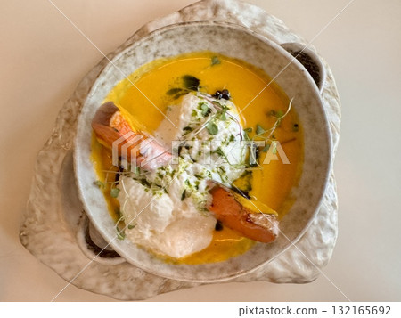 Pumpkin soup with pumpkin seeds, cream and baked pumpkin in the restaurant Pumpkin soup with pumpkin seeds, cream and baked pumpkin in the restaurant 132165692