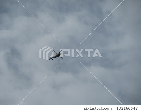 Helicopter flying in the clouds 132166548