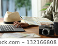 Tourist planning vacation checking maps and laptop 132166808