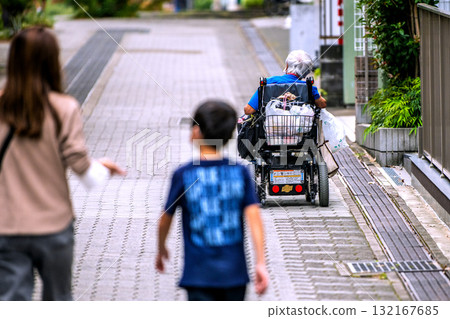 Tokyo cityscape in Japan: Aging society...Elderly people in electric wheelchairs...=7th, Yokohama city 132167685