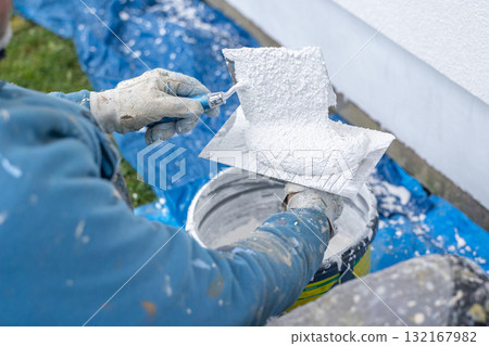 Worker applying plaster material with trowel for renovation Worker applying plaster material with trowel for renovation 132167982