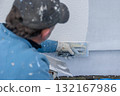 Plasterer applying stucco plaster on building wall 132167986