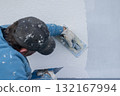 Worker plastering stucco on building exterior wall 132167994