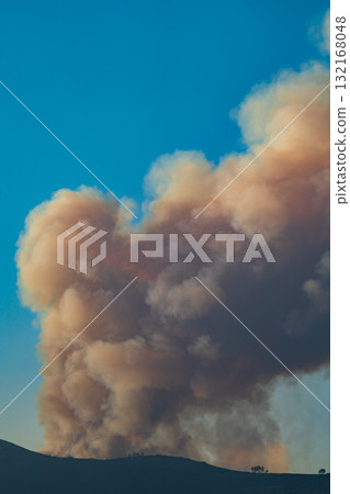 Large Smoke Plume Rising Over Mountain Sky Large Smoke Plume Rising Over Mountain Sky 132168048