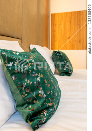 Green and white soft pillows on the bed Green and white soft pillows on the bed 132168406