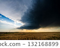Epic scene as incredible supercell storm darkens the sky at sunset 132168899