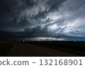 Lightning bolts flash through a dark storm cloud 132168901
