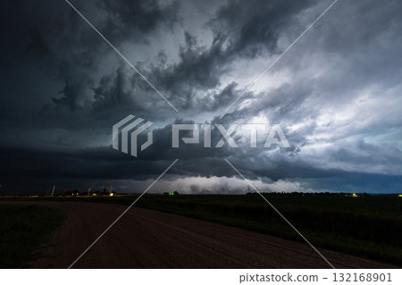 Lightning bolts flash through a dark storm cloud Lightning bolts flash through a dark storm cloud 132168901