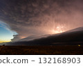 Lightning flickering through approaching storm clouds 132168903