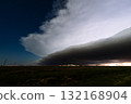 Lightning Lurks Beneath Churning Clouds Above a Silent Countryside 132168904