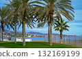A vibrant, sunlit photograph capturing a quintessential Mediterranean beach scene in Malaga, Spain. In the foreground 132169199