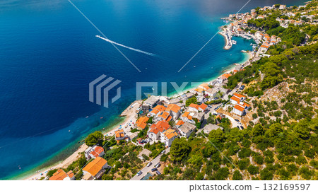 Stunning aerial view of traditional Dalmatian fishing villages along Omis Riviera with turquoise Adriatic waters Croatia Stunning aerial view of traditional Dalmatian fishing villages along Omis Riviera with turquoise Adriatic waters Croatia 132169597